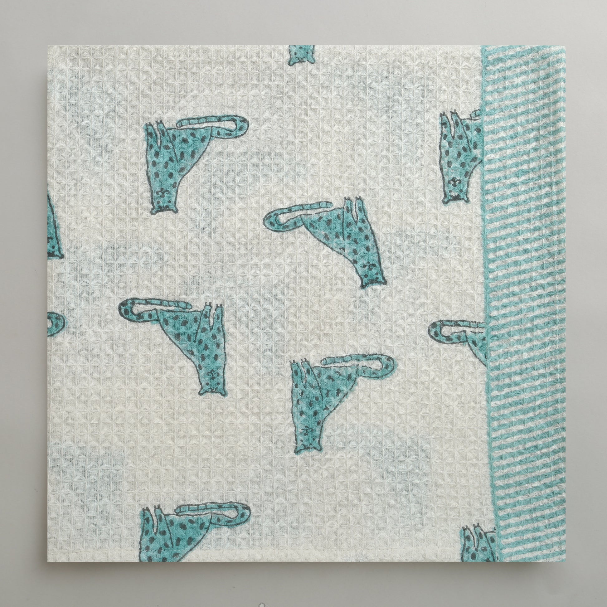 'A Leap of Snow Leopards' Bathing Towel